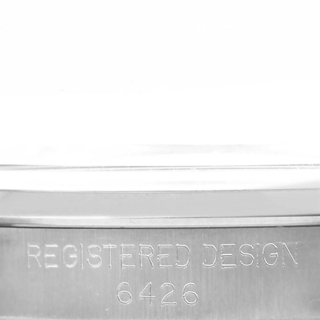 This image shows a close-up of the side of a Rolex Vintage Collection 6426 Men's Stainless Steel Silver Dial 6426 Men's Stainless Steel Silver Dial model, highlighting the "Registered Design 6426" engraving.