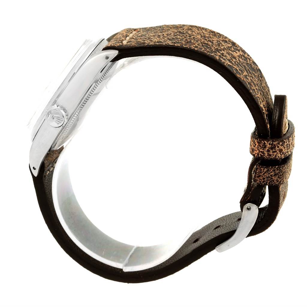 This image shows the side view of a Vintage Collection Rolex watch with a weathered leather strap and visible crown.