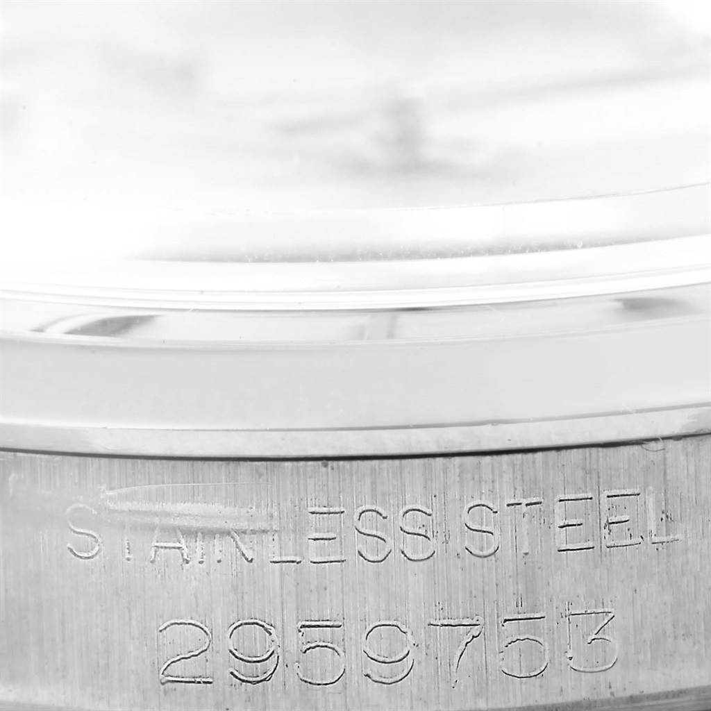 This close-up angle shows the serial number and "Stainless Steel" engraving on the side of the Rolex Vintage Collection 1500 Men's Stainless Steel Silver Dial 1500 Men's Stainless Steel Silver Dial model's case.