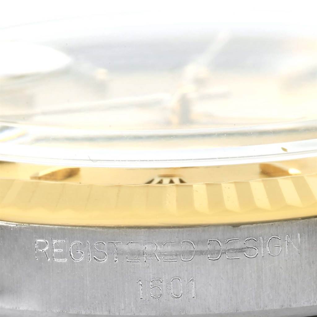 The image shows a close-up side view of the bezel and case of a Vintage Collection Rolex model, displaying the "REGISTERED DESIGN 1601" engraving.