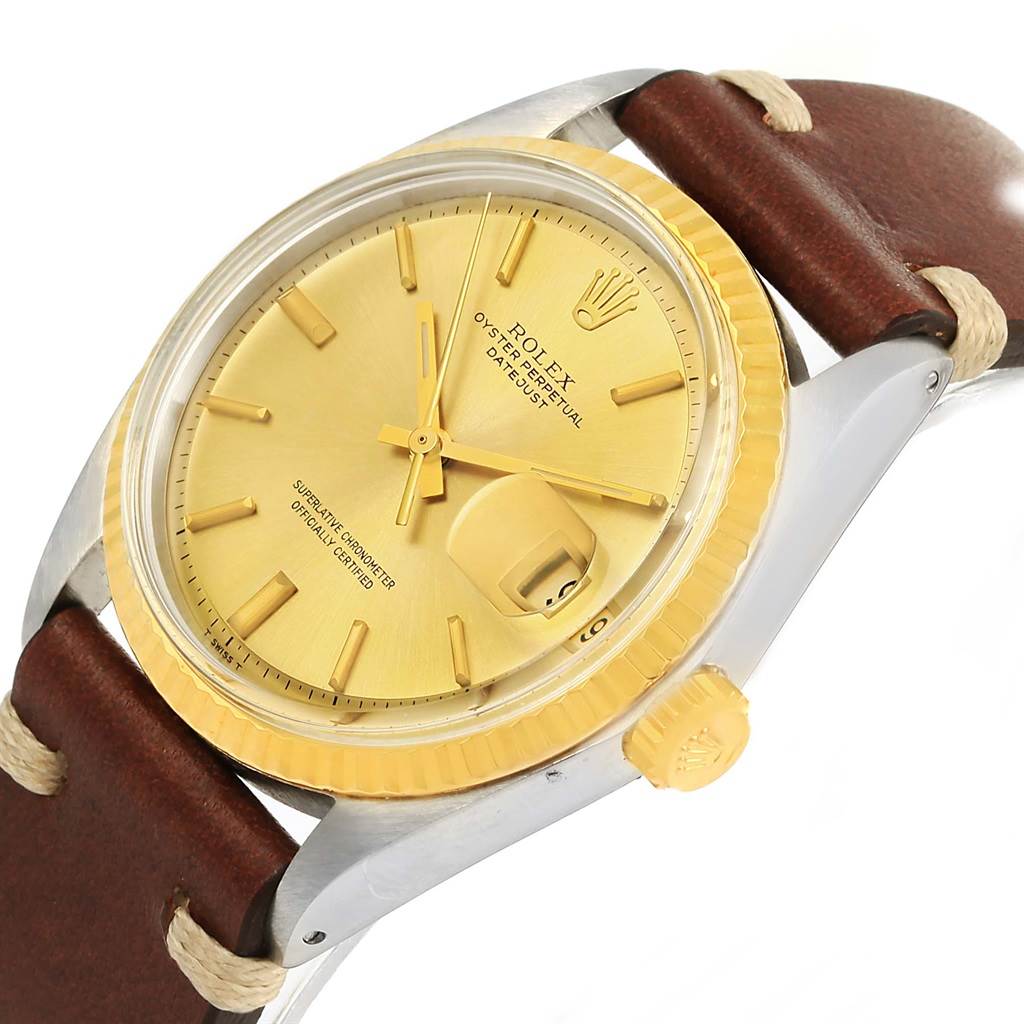 The image shows a close-up of the Rolex Vintage Collection 1601 Men's Steel and Gold (two tone) Champagne Dial 1601 Men's Steel and Gold (two tone) Champagne Dial watch, highlighting its gold face, crown, and brown leather strap.