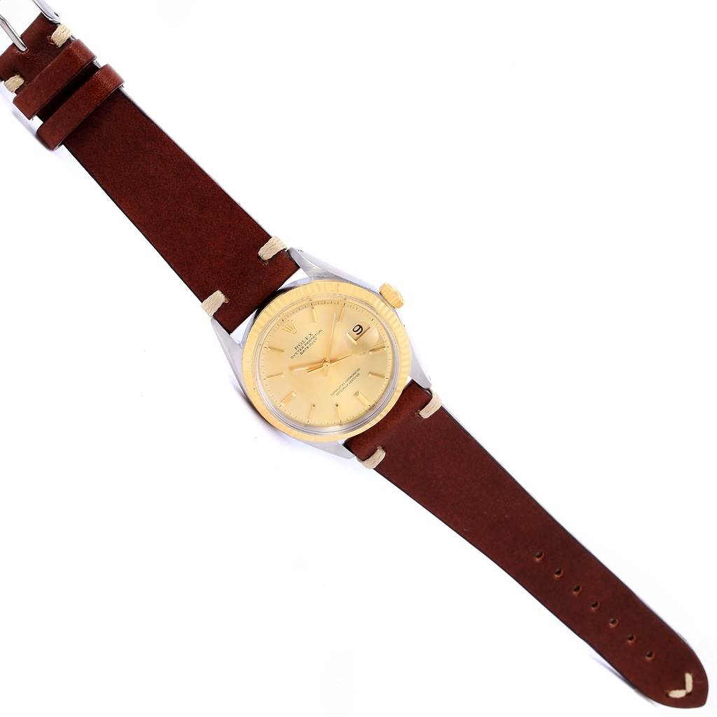 This image shows the Rolex Vintage Collection 1601 Men's Steel and Gold (two tone) Champagne Dial 1601 Men's Steel and Gold (two tone) Champagne Dial model watch from a top-down angle, displaying its face and brown leather strap.