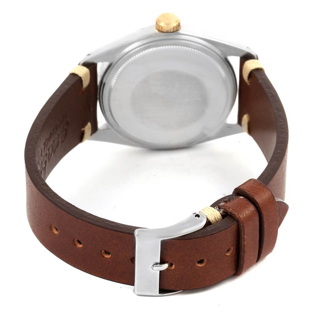 This image shows the back and the leather strap of a Rolex Vintage Collection 1601 Men's Steel and Gold (two tone) Champagne Dial 1601 Men's Steel and Gold (two tone) Champagne Dial watch from a rear angle.