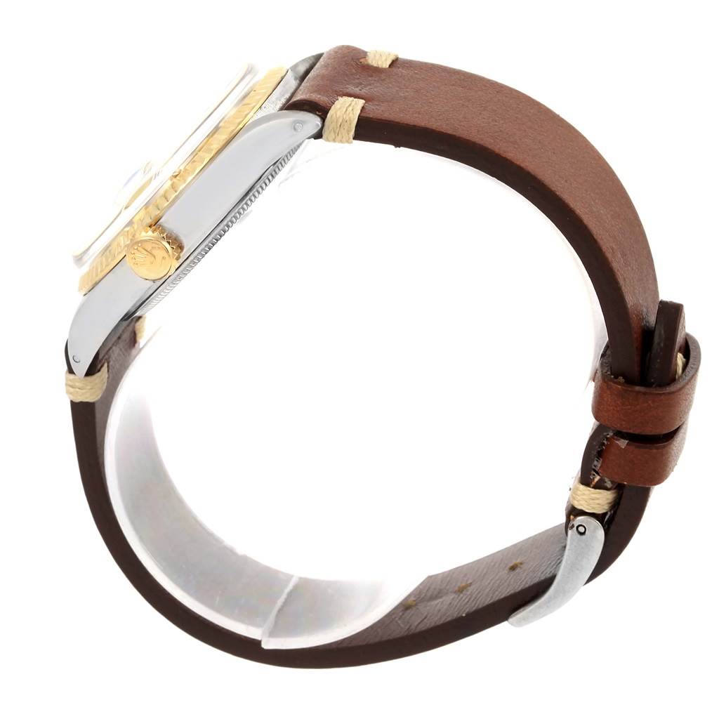 This image shows a Vintage Collection Rolex watch from a side angle, featuring its crown, bezel, case, and leather strap.