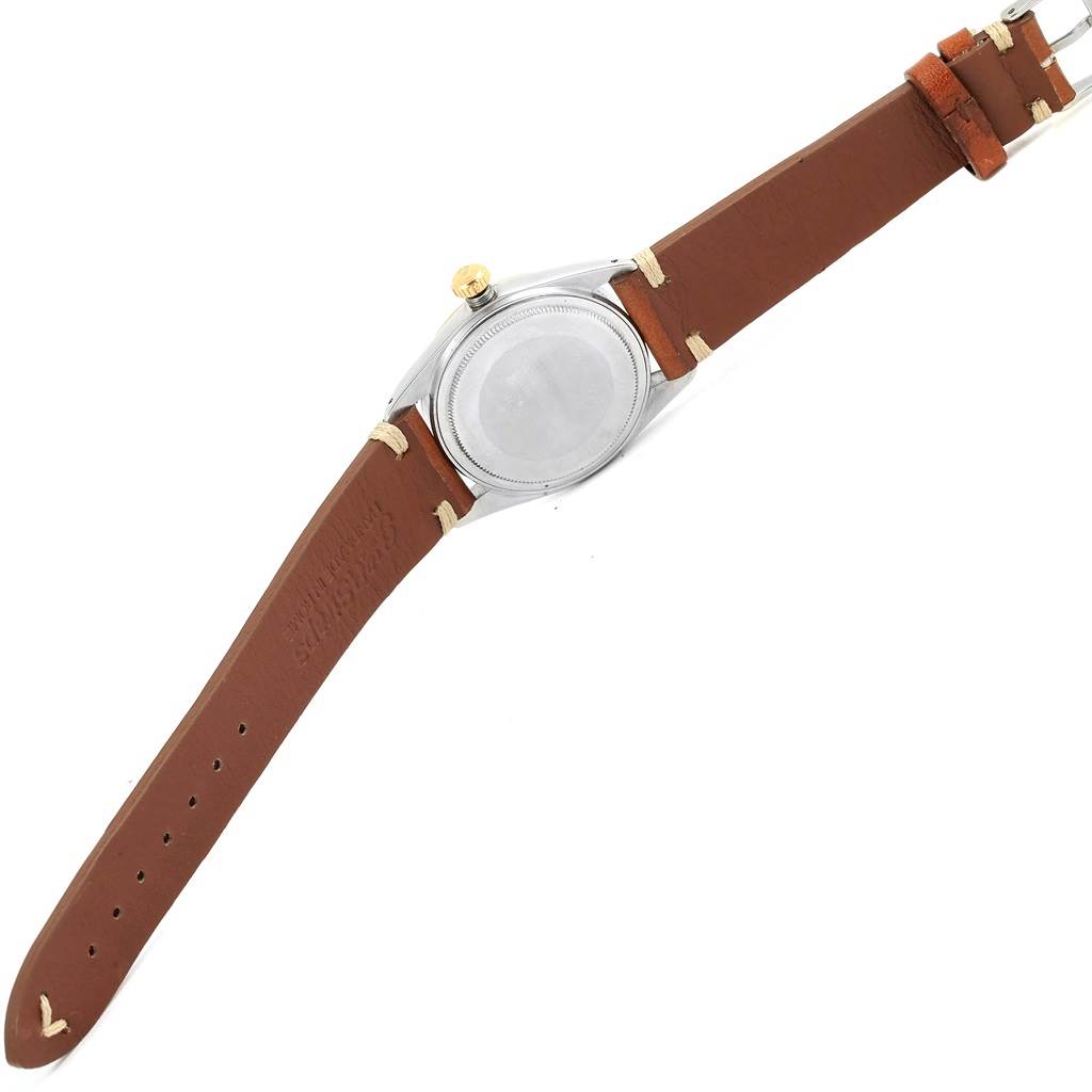 The image shows the back of the Rolex Vintage Collection 1601 Men's Steel and Gold (two tone) Champagne Dial 1601 Men's Steel and Gold (two tone) Champagne Dial watch with its brown leather strap.