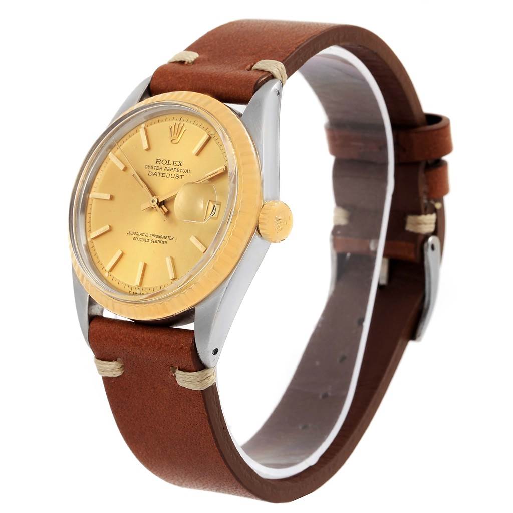 The image shows a side angle of a Rolex Vintage Collection 1601 Men's Steel and Gold (two tone) Champagne Dial 1601 Men's Steel and Gold (two tone) Champagne Dial Datejust watch with a brown leather strap and gold-tone dial and bezel.