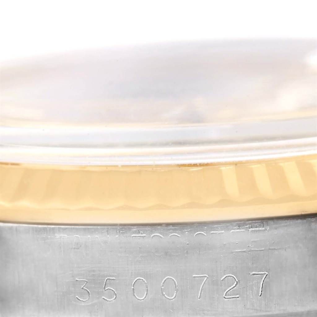 The image shows a close-up of the serial number and the edge of the bezel of a Rolex Vintage Collection 1601 Men's Steel and Gold (two tone) Champagne Dial 1601 Men's Steel and Gold (two tone) Champagne Dial model watch.