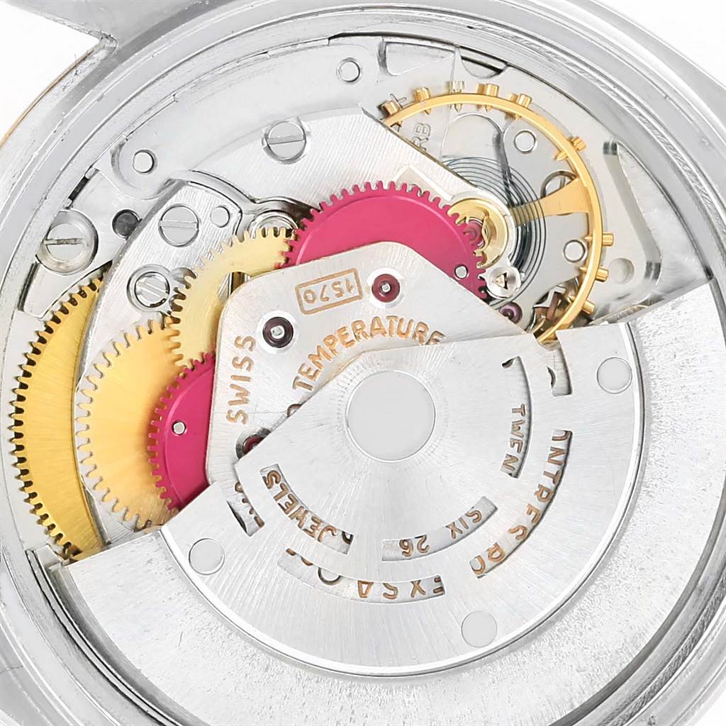 This image shows the intricate inner mechanical movement of a Vintage Collection model by Rolex, viewed from the back.