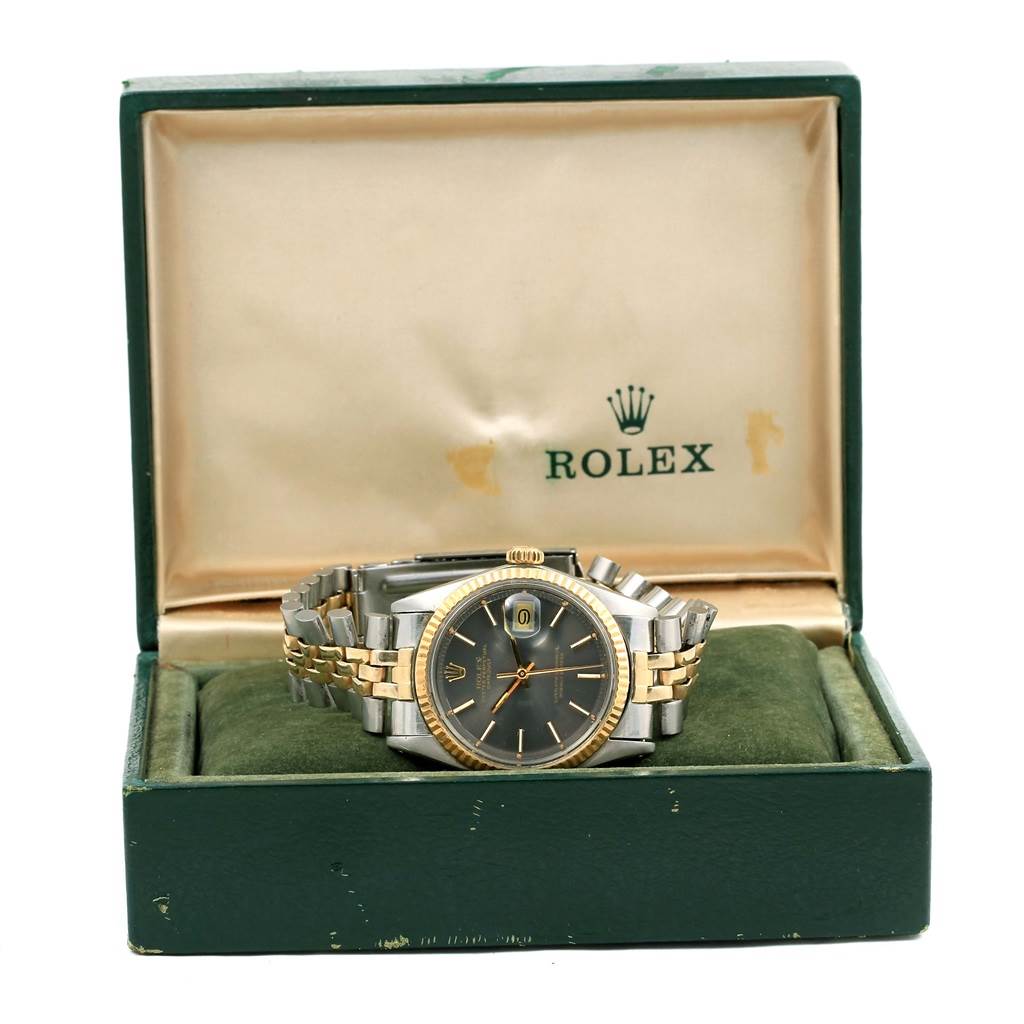 The Rolex Vintage Collection 1601 Men's Steel and Gold (two tone) Grey Dial 1601 Men's Steel and Gold (two tone) Grey Dial watch is displayed frontally inside its branded box, showing its face and bracelet.