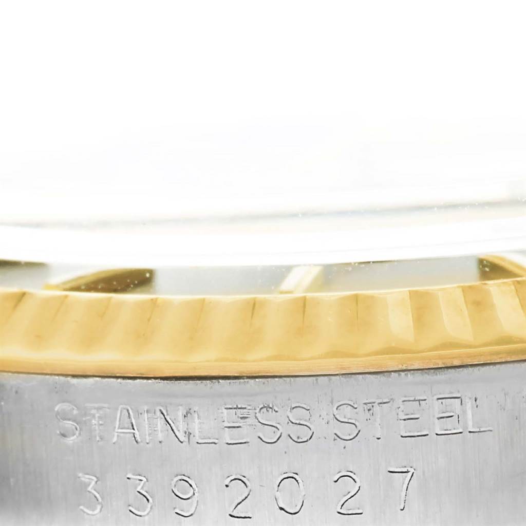 The image shows a close-up of the case back and the rim of the bezel for a Rolex Vintage Collection 1601 Men's Steel and Gold (two tone) Grey Dial 1601 Men's Steel and Gold (two tone) Grey Dial watch with engraved serial numbers.