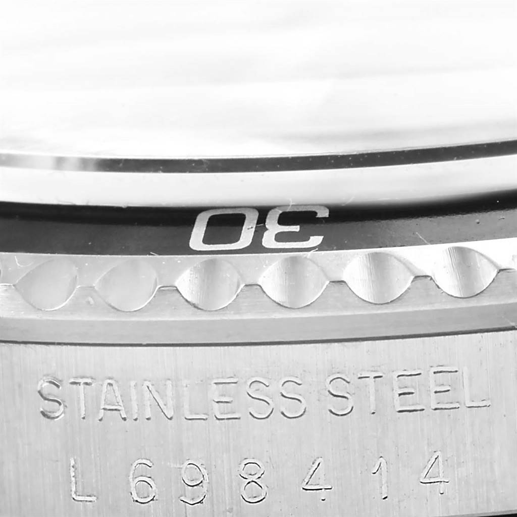 This close-up view of the Rolex Vintage Collection 5513 Men's Stainless Steel Black Dial 5513 Men's Stainless Steel Black Dial watch showcases the bezel and the engraved stainless steel case.