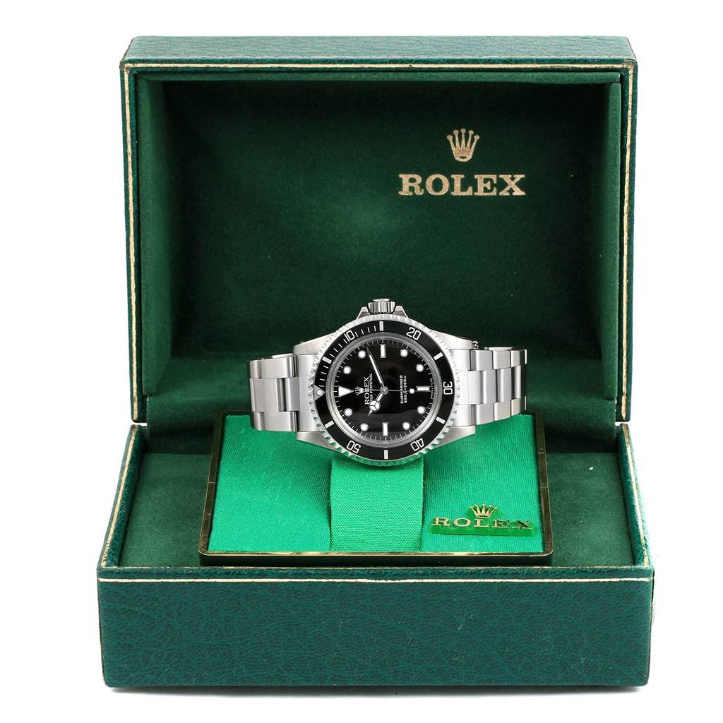The Vintage Collection Rolex watch is displayed front-on, in an open green Rolex box.