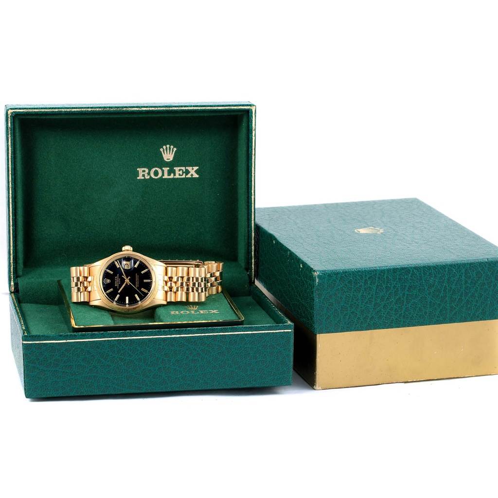 The Rolex Vintage Collection 1513 Men's Yellow Gold Black Dial 1513 Men's Yellow Gold Black Dial watch is shown from the front, neatly placed inside its green and gold box.