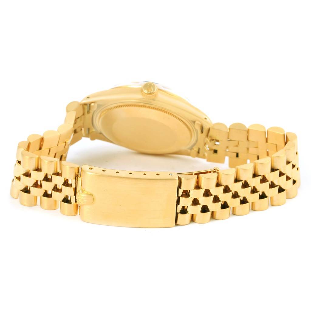 The image shows the back view of a Rolex Vintage Collection 1513 Men's Yellow Gold Black Dial 1513 Men's Yellow Gold Black Dial model watch, highlighting its gold bracelet and clasp.