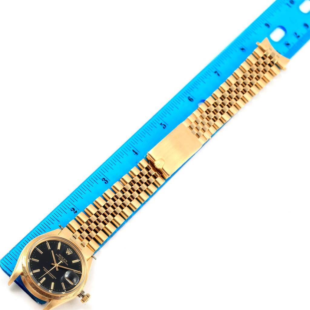 The image shows a full view of the Rolex Vintage Collection 1513 Men's Yellow Gold Black Dial 1513 Men's Yellow Gold Black Dial watch, with its gold band and black dial, alongside a ruler for scale.