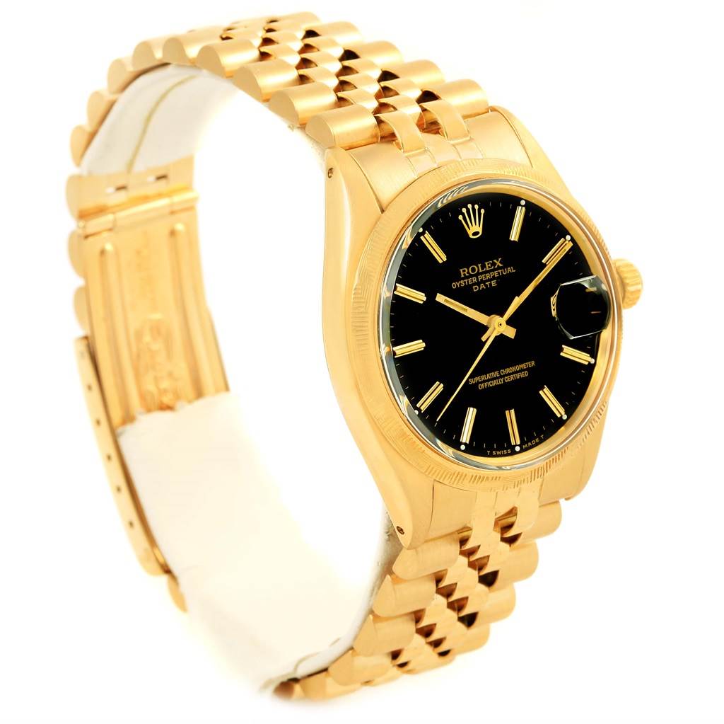This Vintage Collection Rolex watch is shown from a side angle, highlighting its gold bracelet, black dial, and crown.