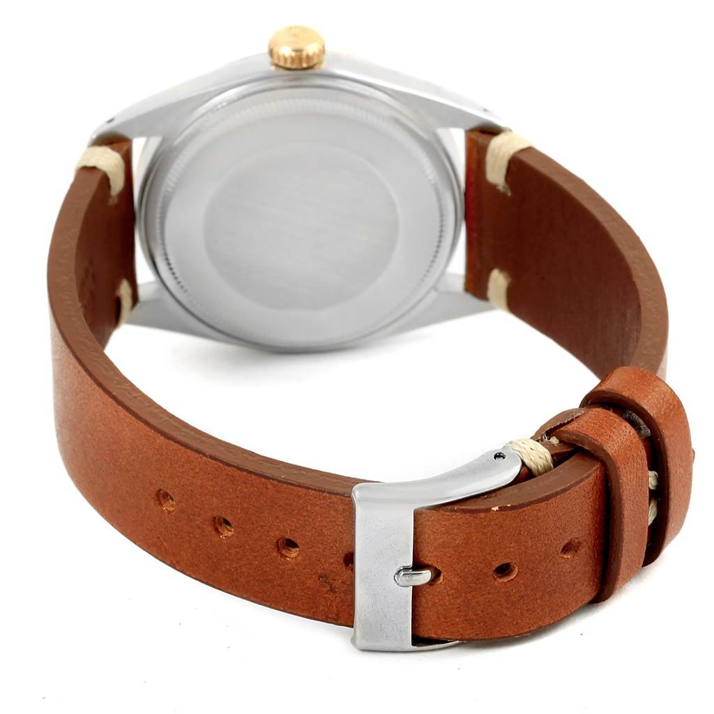 This image shows the back view of a Rolex Vintage Collection 1601 Men's Steel and Gold (two tone) Champagne Dial 1601 Men's Steel and Gold (two tone) Champagne Dial watch, featuring its brown leather strap and stainless steel buckle.