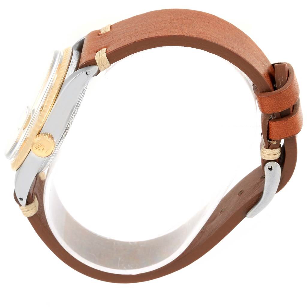 The Rolex Vintage Collection 1601 Men's Steel and Gold (two tone) Champagne Dial 1601 Men's Steel and Gold (two tone) Champagne Dial watch is shown from the side, highlighting the case, crown, and brown leather strap.