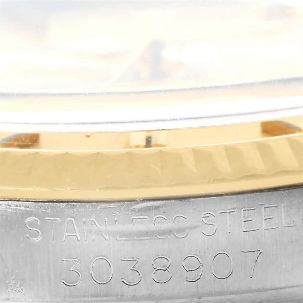 The image shows a close-up of the side of a Vintage Collection Rolex watch, highlighting the serial number and stainless steel text.