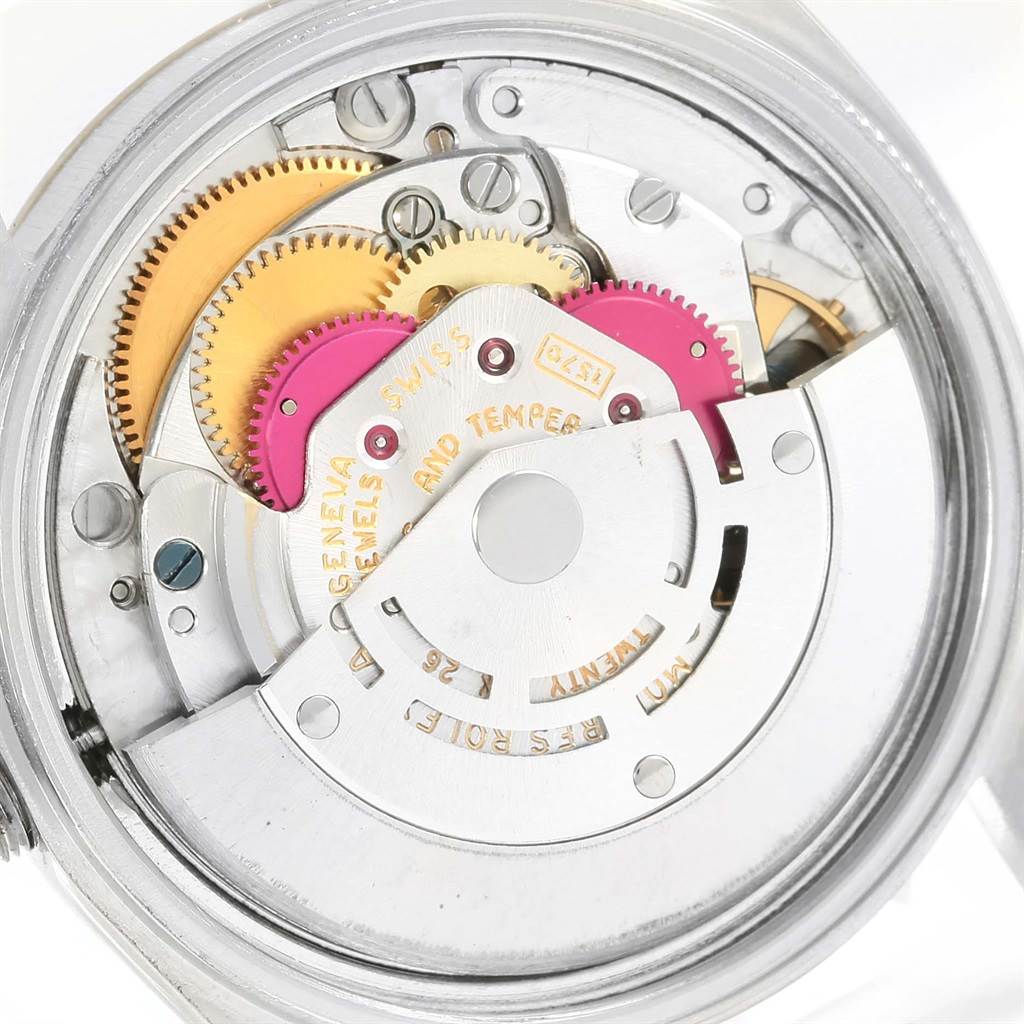 The image shows the intricate internal mechanism of the Rolex Vintage Collection 1601 Men's Steel and Gold (two tone) Champagne Dial 1601 Men's Steel and Gold (two tone) Champagne Dial model, focusing on the gears and movement parts.