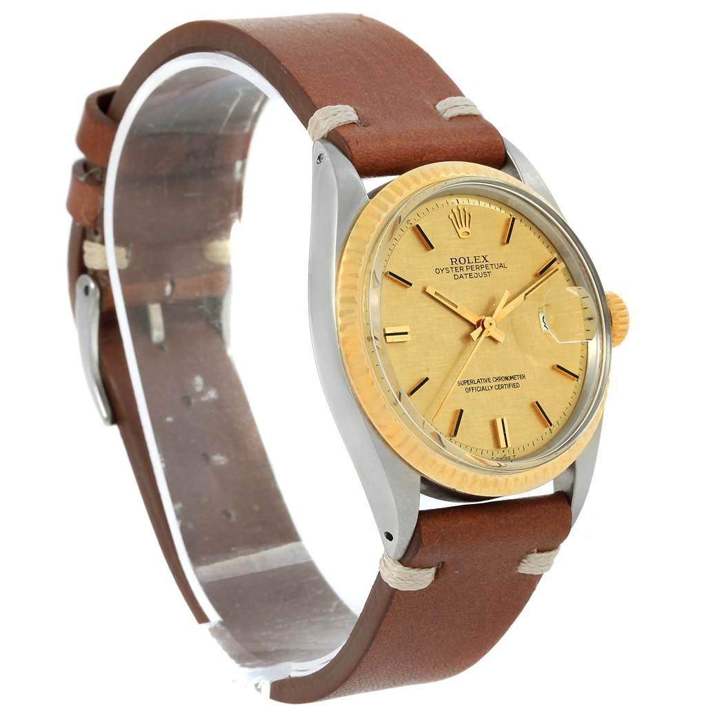 The image shows a Rolex Vintage Collection 1601 Men's Steel and Gold (two tone) Champagne Dial 1601 Men's Steel and Gold (two tone) Champagne Dial watch from a side angle, highlighting its brown leather strap, gold dial, and bezel.