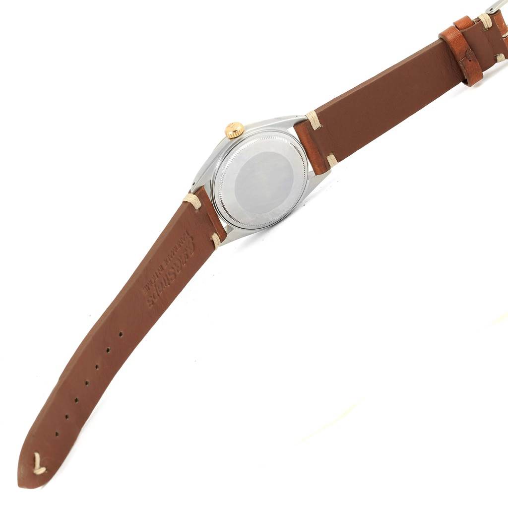 The image shows the back and side of a Rolex Vintage Collection 1601 Men's Steel and Gold (two tone) Champagne Dial 1601 Men's Steel and Gold (two tone) Champagne Dial watch with a brown leather strap.