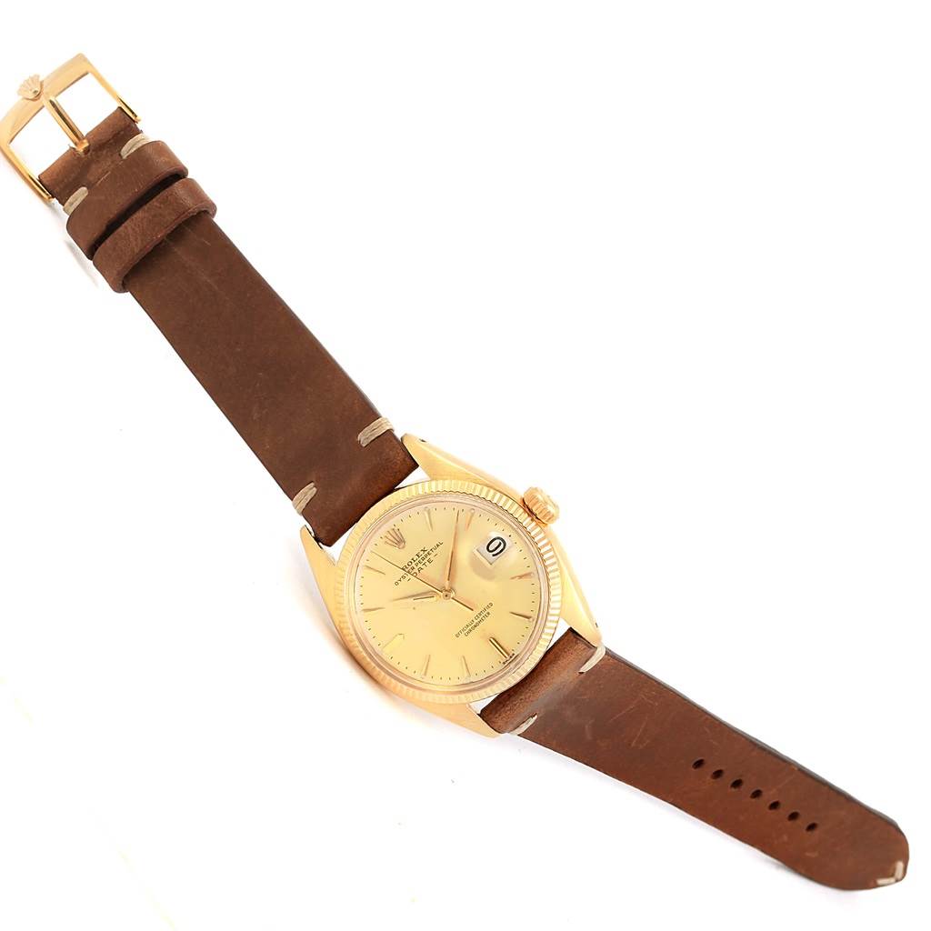 The image shows a Rolex Vintage Collection 6537 Men's Yellow Gold Champagne Dial 6537 Men's Yellow Gold Champagne Dial watch from a top-down angle, featuring the dial, case, crown, and brown leather strap with buckle.