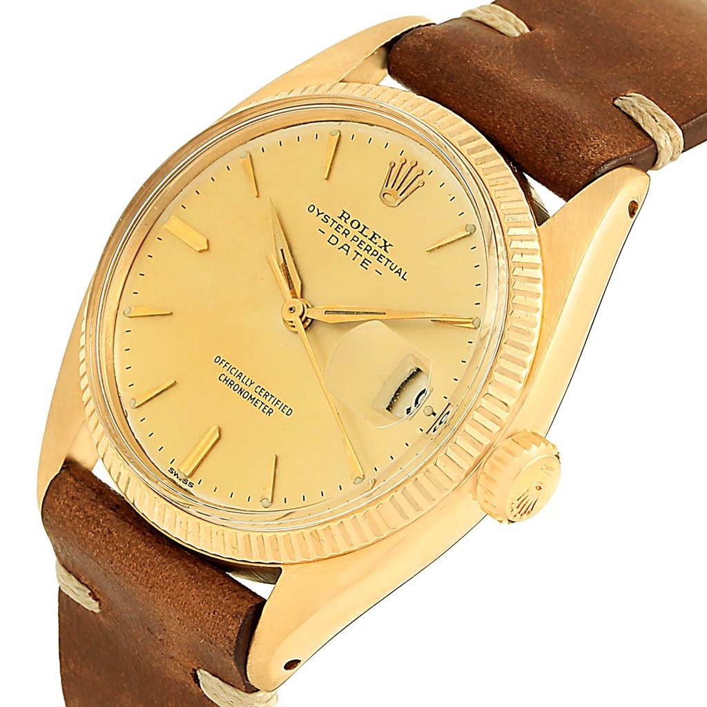 This image shows a Rolex Vintage Collection 6537 Men's Yellow Gold Champagne Dial 6537 Men's Yellow Gold Champagne Dial Oyster Perpetual Date watch at a tilted angle, highlighting the dial, bezel, and leather strap.