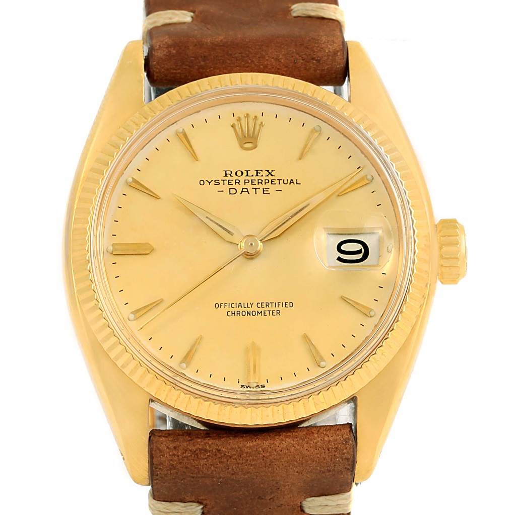 The image shows a Rolex Vintage Collection 6537 Men's Yellow Gold Champagne Dial 6537 Men's Yellow Gold Champagne Dial Oyster Perpetual Date watch with a leather strap, gold dial, and magnified date window at 3 o'clock.