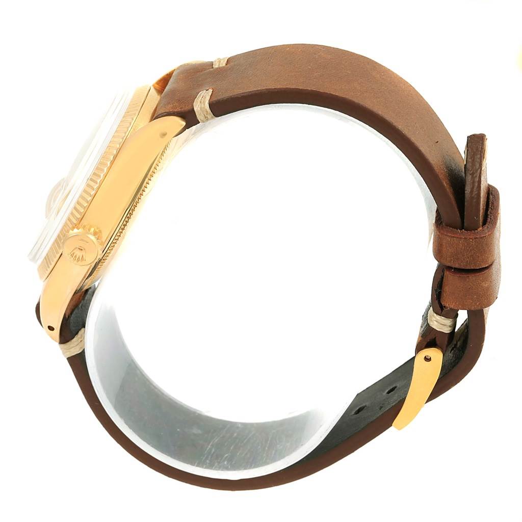 The image shows a side view of the Rolex Vintage Collection 6537 Men's Yellow Gold Champagne Dial 6537 Men's Yellow Gold Champagne Dial watch, highlighting the crown, case, and leather strap.