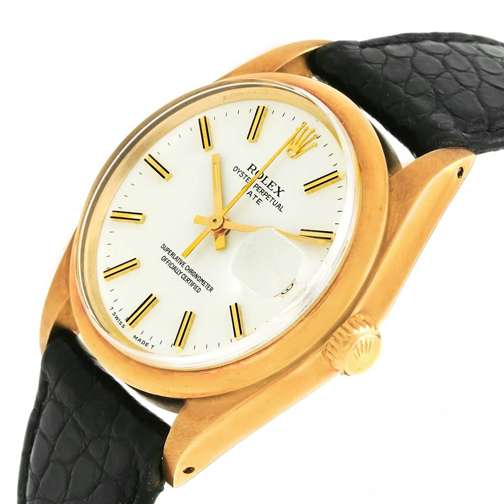 The image shows a close-up angle of the Rolex Vintage Collection 1500 Men's Yellow Gold White Dial 1500 Men's Yellow Gold White Dial model, highlighting the white dial, gold hands, and black strap.
