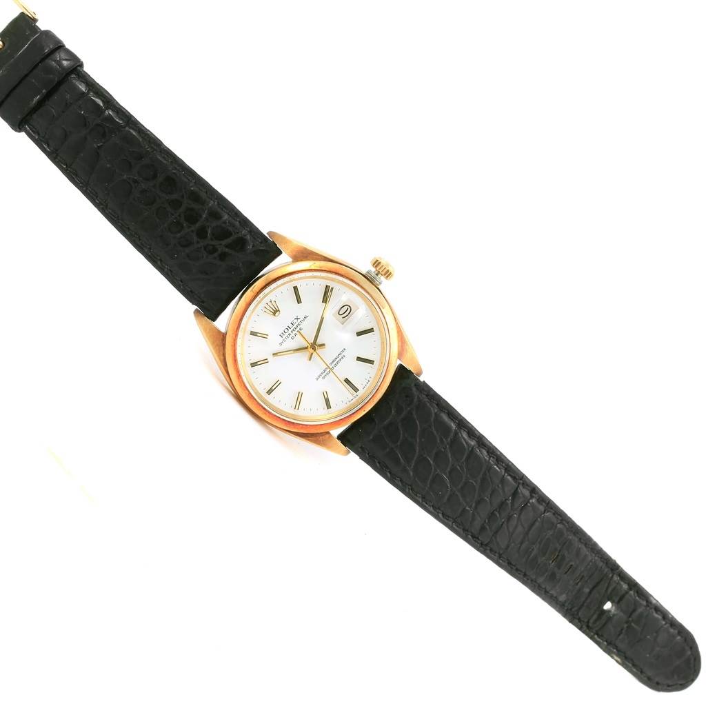 The Rolex Vintage Collection 1500 Men's Yellow Gold White Dial 1500 Men's Yellow Gold White Dial watch is shown at a top-down angle, displaying the dial, case, crown, and black leather strap.