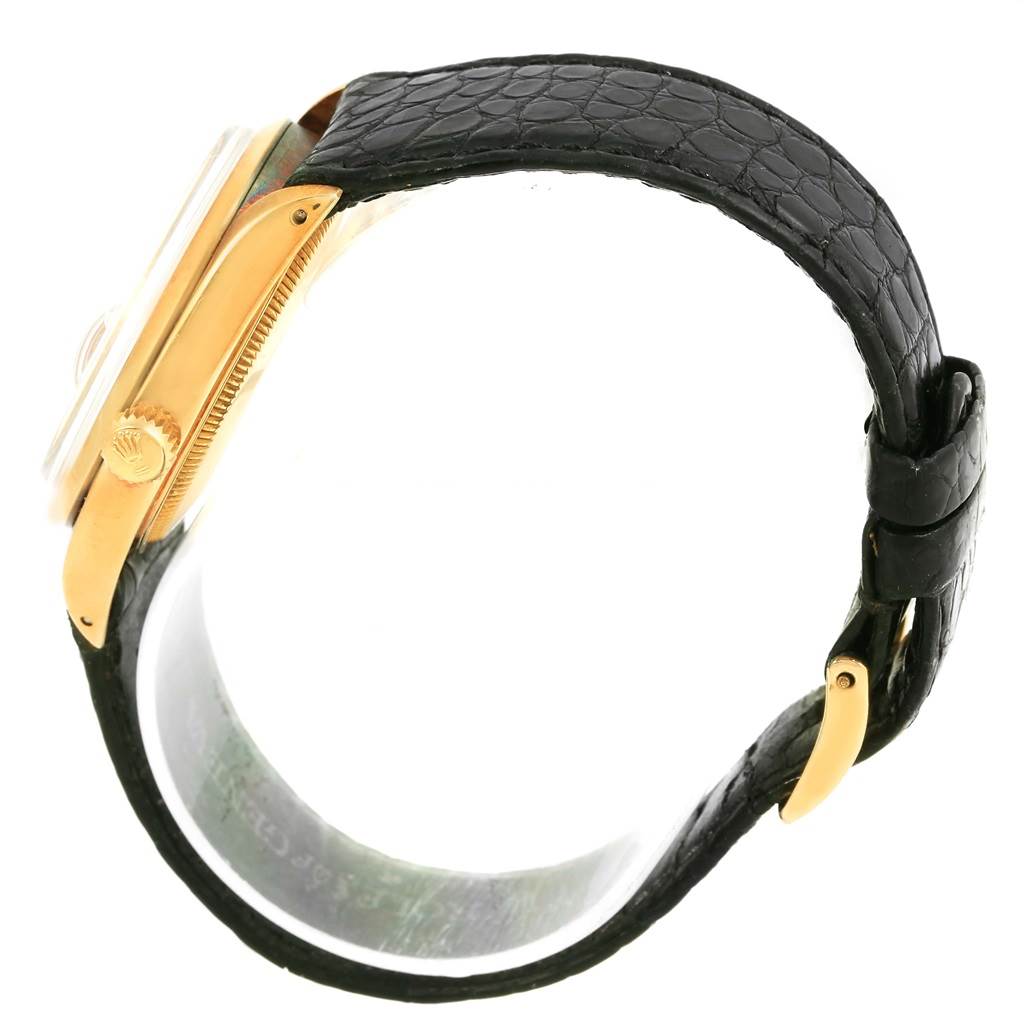 This image shows a side view of the Rolex Vintage Collection 1500 Men's Yellow Gold White Dial 1500 Men's Yellow Gold White Dial model, highlighting the bezel, crown, and leather strap.