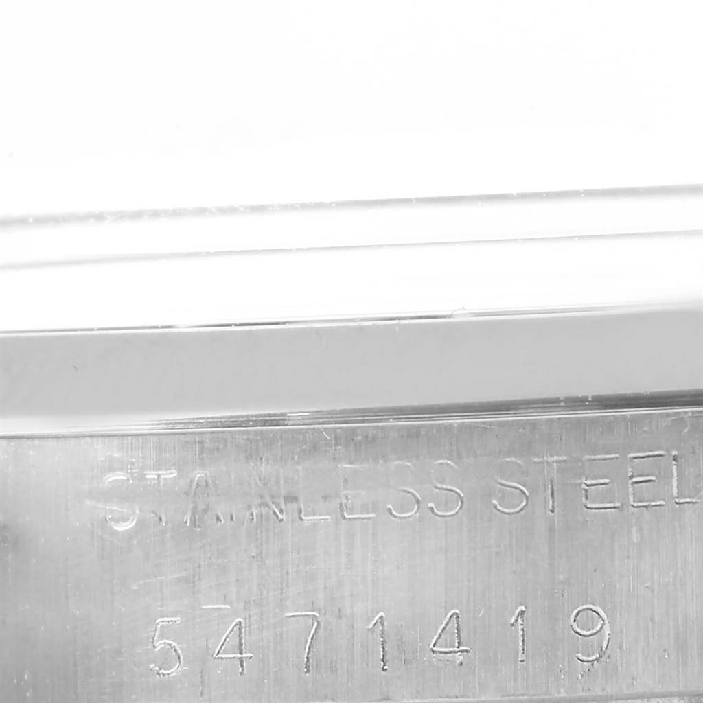 This image shows a close-up of the serial number and "Stainless Steel" engraving on the side of a Rolex Vintage Collection 6694 Men's Stainless Steel Blue Dial 6694 Men's Stainless Steel Blue Dial watch.