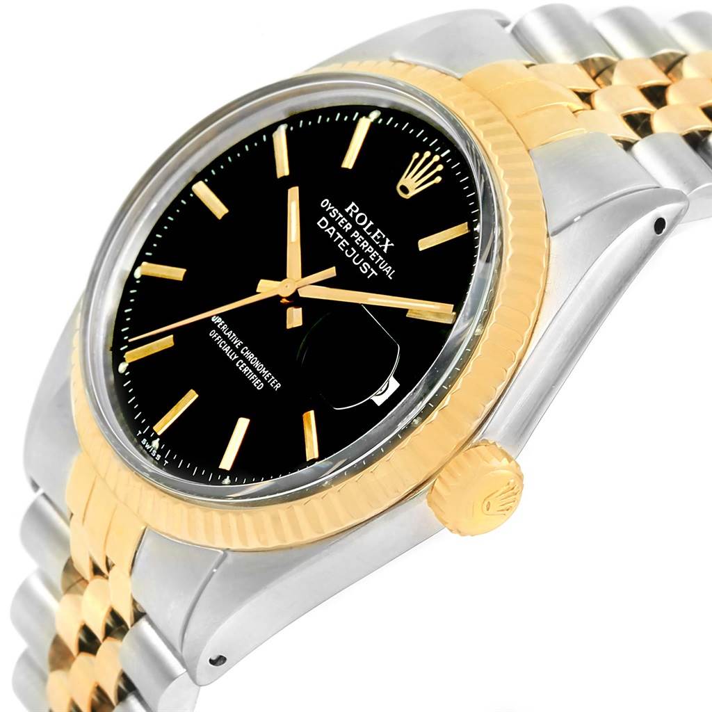 The image shows a close-up side angle of the Rolex Oyster Perpetual Datejust Vintage Collection watch, highlighting its black dial, gold bezel, and two-tone bracelet.