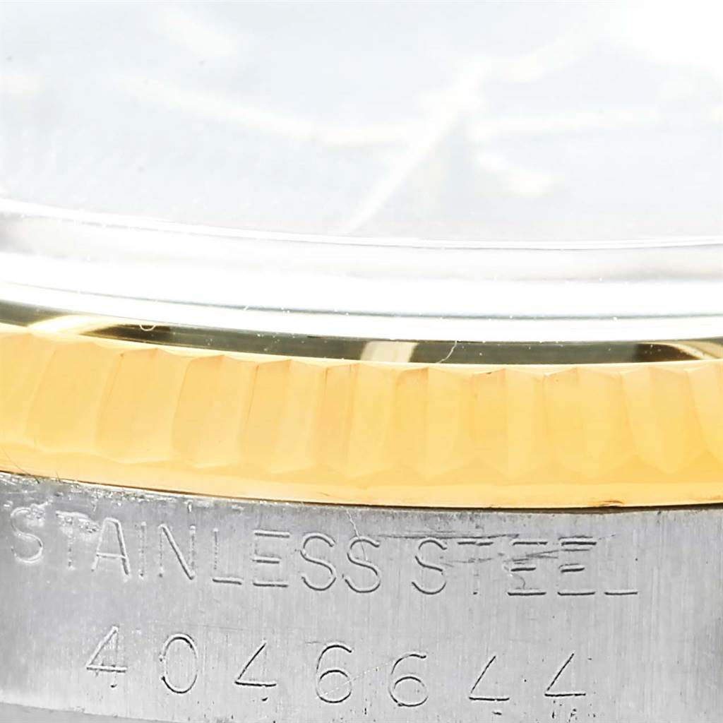The image shows a close-up of the Rolex Vintage Collection 1603 Men's Steel and Gold (two tone) Black Dial 1603 Men's Steel and Gold (two tone) Black Dial watch, highlighting part of the bezel and serial number engraving.