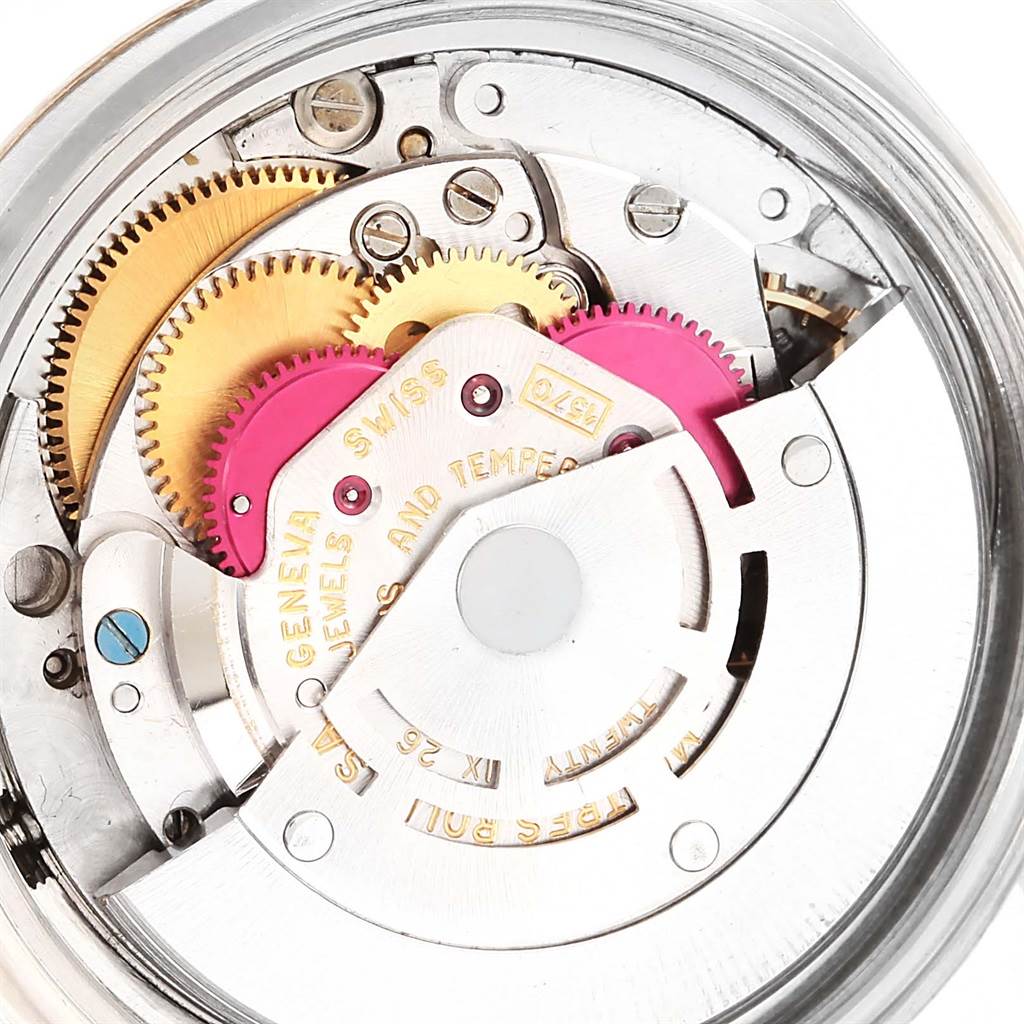 The image shows an internal mechanism view of a Vintage Collection Rolex watch, highlighting its gears and intricate components.