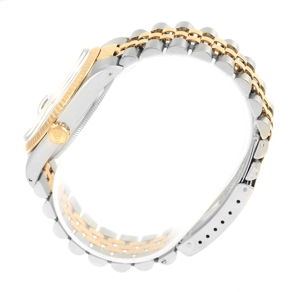 This image shows a side angle of a Rolex Vintage Collection 16013 Men's Stainless Steel Silver Dial 16013 Men's Stainless Steel Silver Dial watch, highlighting the crown, bezel, and two-tone bracelet.