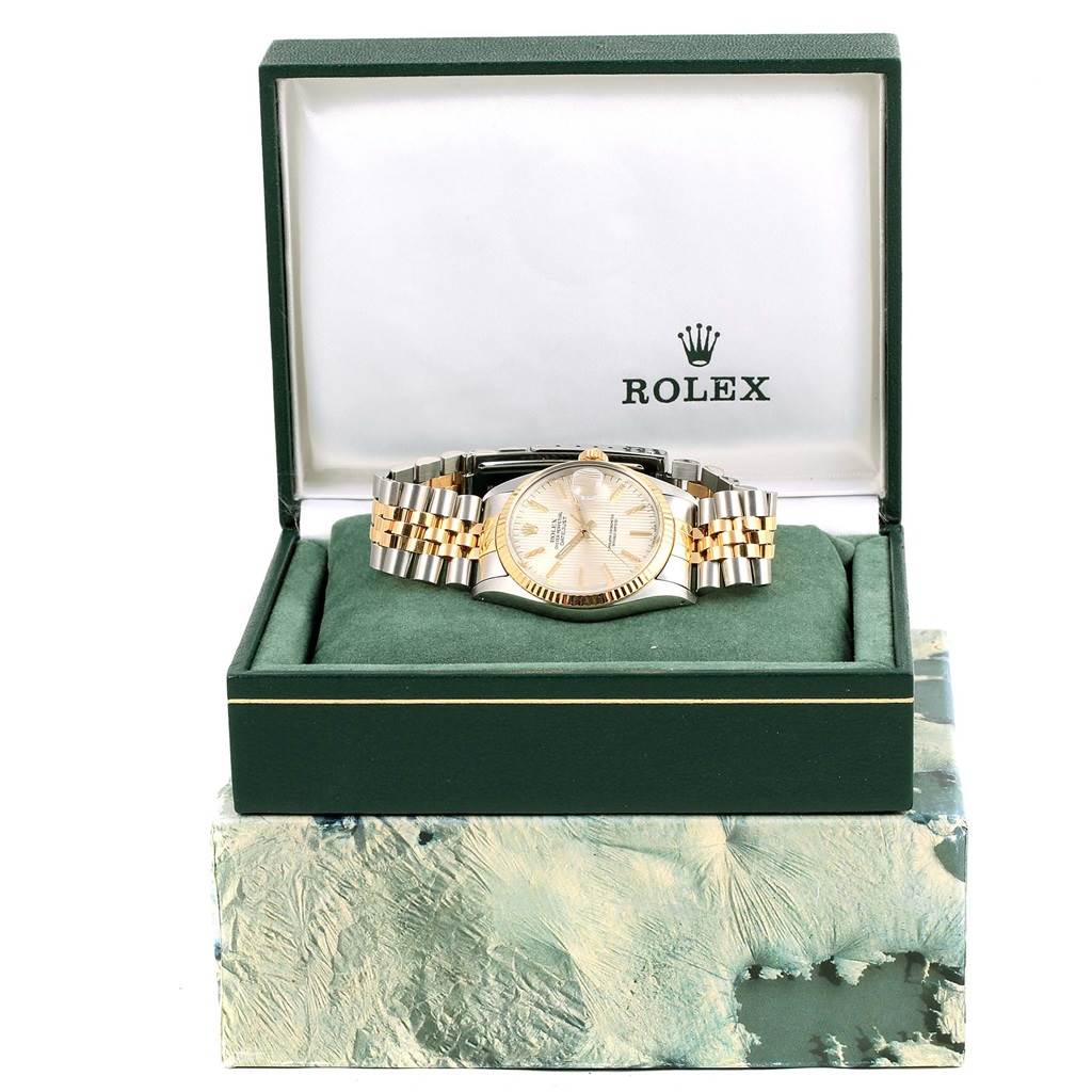 The Vintage Collection Rolex watch is displayed frontally inside its open green box, showcasing the dial and bracelet.