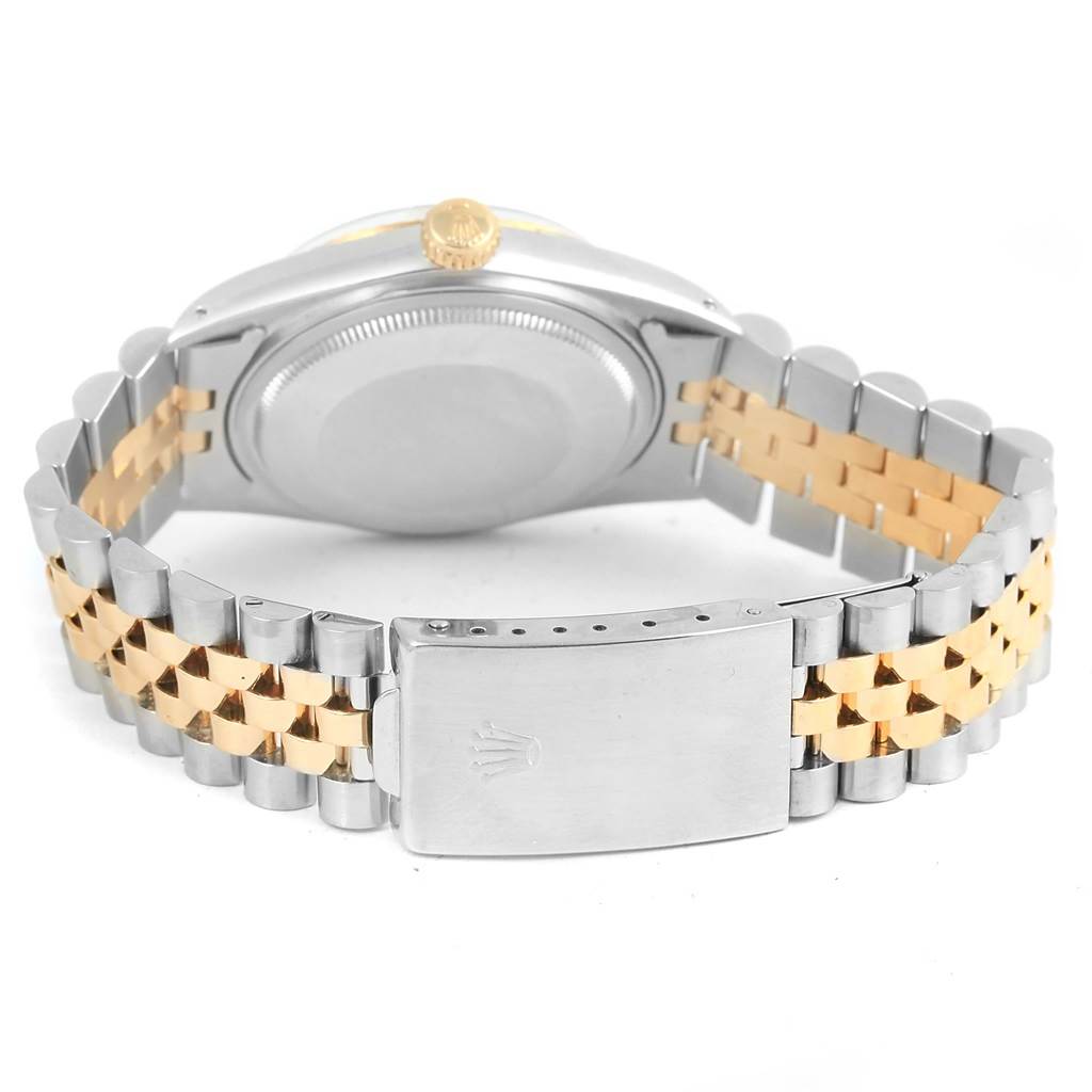 The image shows the back view of a Rolex Vintage Collection 16013 Men's Stainless Steel Champagne Dial 16013 Men's Stainless Steel Champagne Dial watch, highlighting its clasp, bracelet, case back, and crown.