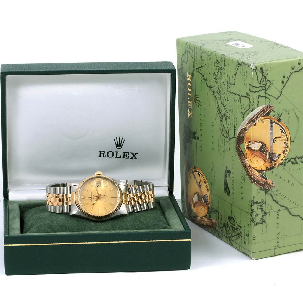 The Vintage Collection Rolex watch is shown from the front, displayed in its open box alongside its branded packaging.