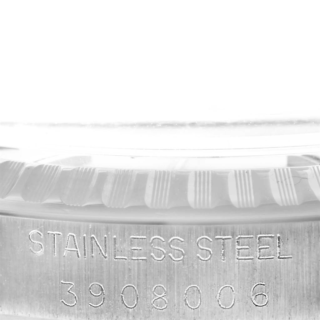 This image shows a close-up angle of the side of a Rolex Vintage Collection 1603 Men's Stainless Steel Silver Dial 1603 Men's Stainless Steel Silver Dial watch, highlighting its stainless steel case and serial number.