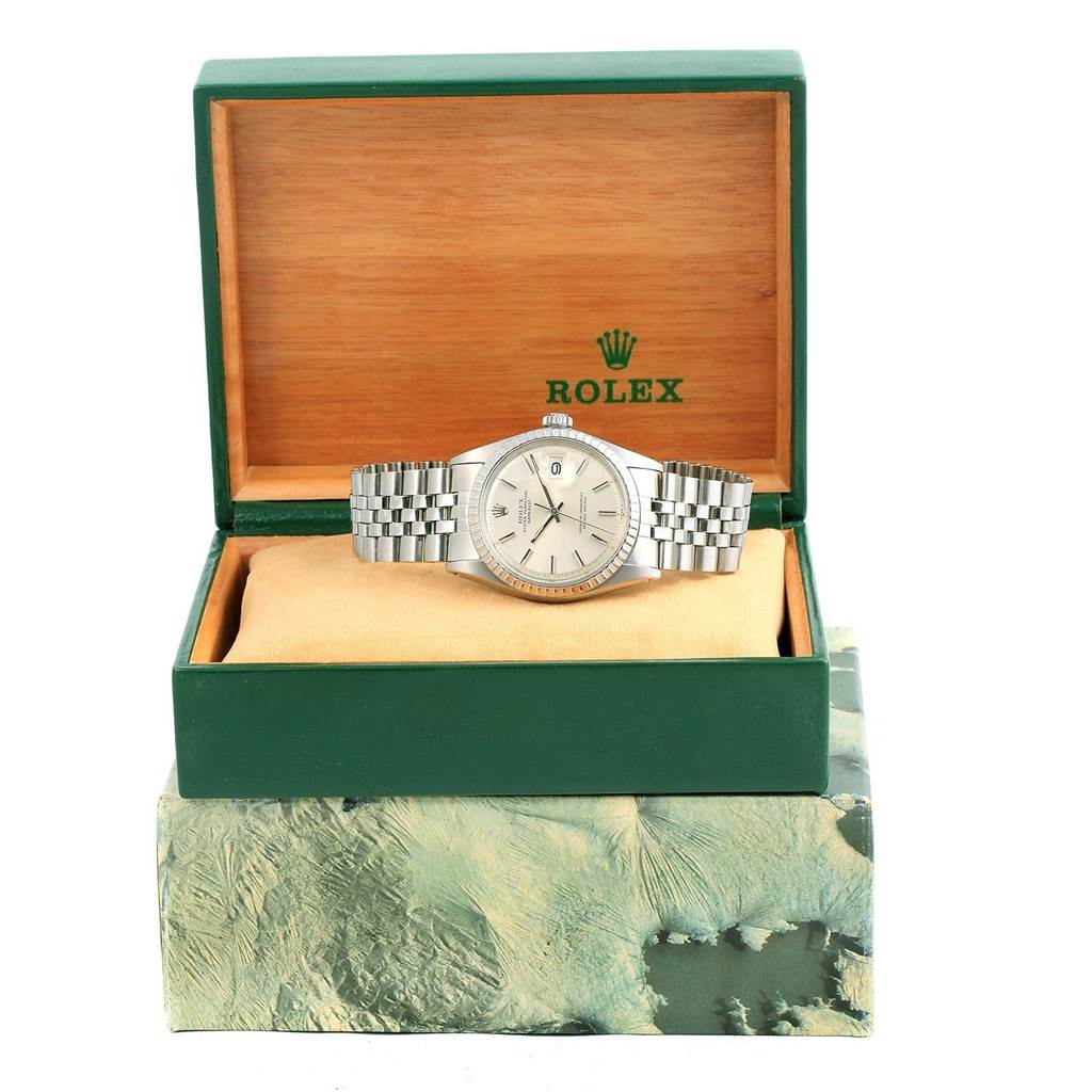 The photo shows a Rolex Vintage Collection 1603 Men's Stainless Steel Silver Dial 1603 Men's Stainless Steel Silver Dial watch from a frontal angle, displayed in an open green box with a tan interior.