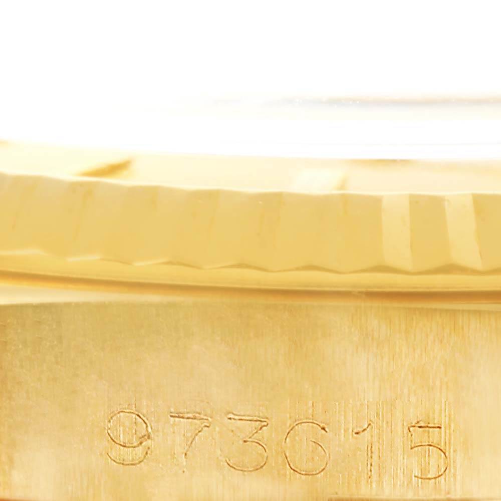This image shows a close-up of the case's edge and engraved serial number of a Rolex Vintage Collection 1601 Men's Yellow Gold Champagne Dial 1601 Men's Yellow Gold Champagne Dial model watch.