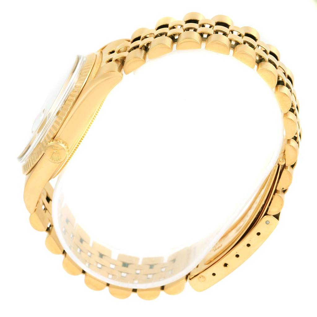 The image shows a side view of a Rolex Vintage Collection 1601 Men's Yellow Gold Champagne Dial 1601 Men's Yellow Gold Champagne Dial watch, focusing on the bracelet, crown, and case.