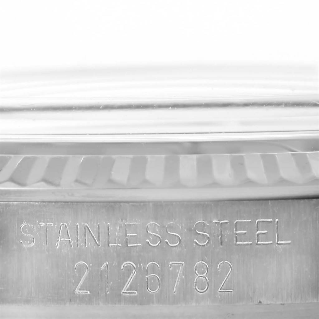 The image shows a close-up of the side view of a Rolex Vintage Collection 1601 Men's Stainless Steel Grey Dial 1601 Men's Stainless Steel Grey Dial model, focusing on the stainless steel engraving and serial number.