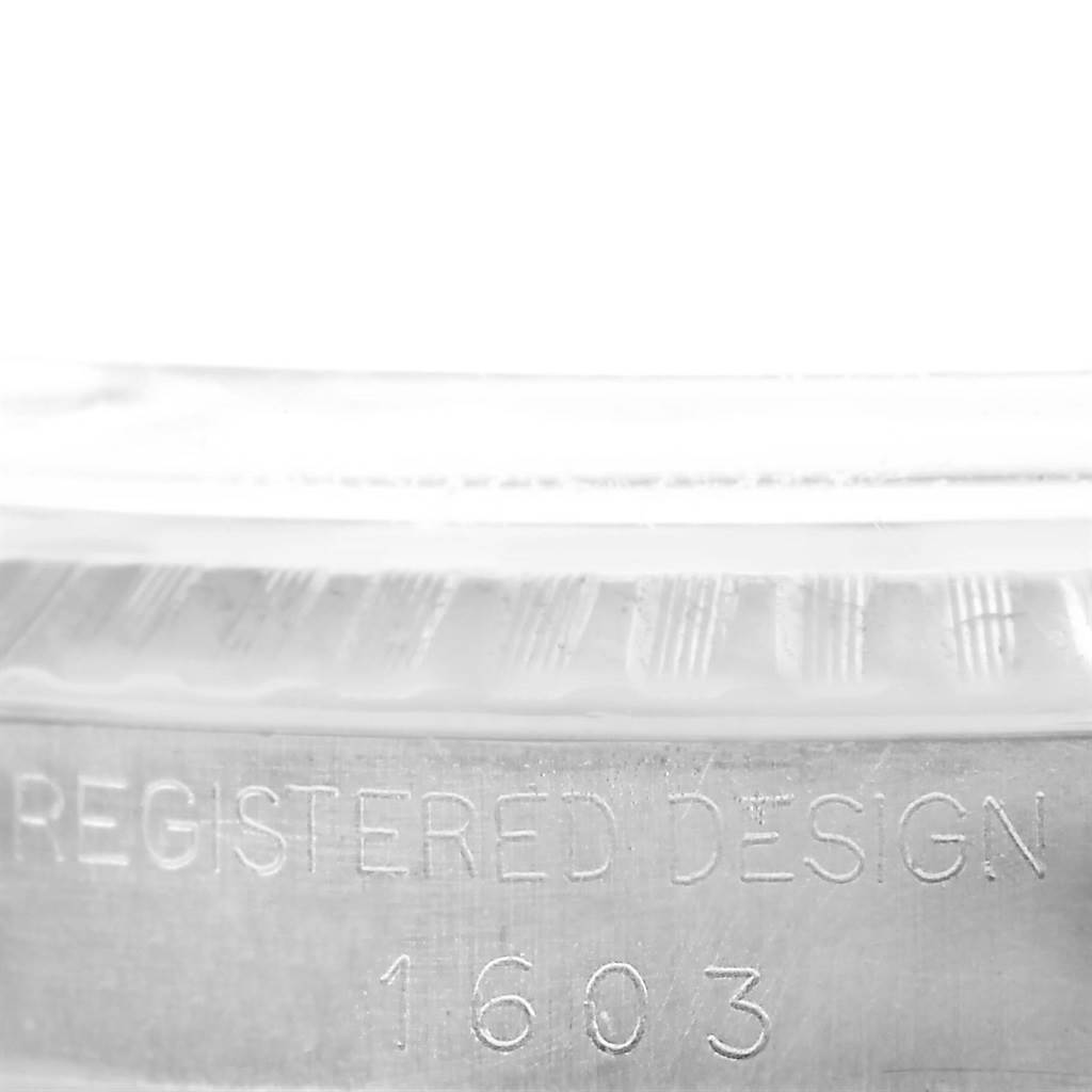 The image shows the side view of a Rolex Vintage Collection 1603 Men's Stainless Steel Silver Dial 1603 Men's Stainless Steel Silver Dial watch case with "REGISTERED DESIGN 1603" engraved.