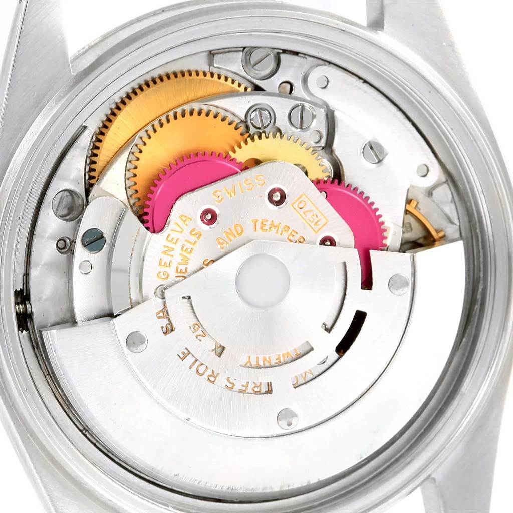 The image shows a close-up view of the inner mechanism of a Rolex Vintage Collection 1603 Men's Stainless Steel Silver Dial 1603 Men's Stainless Steel Silver Dial watch, highlighting its gears and components.