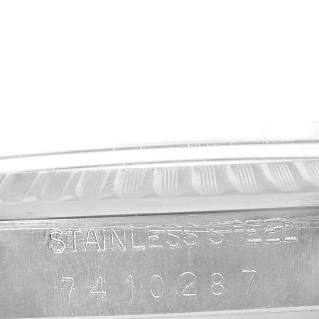 This close-up image shows the serial number and "STAINLESS STEEL" engraving on the case side of a Rolex Vintage Collection 16030 Men's Stainless Steel Grey Dial 16030 Men's Stainless Steel Grey Dial watch.