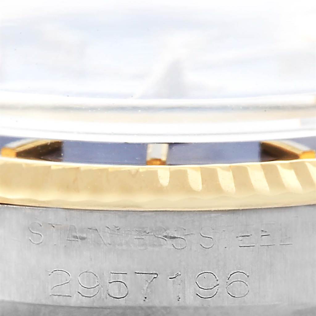 This image shows a close-up, side angle of the bezel and case, with the serial number visible on the Rolex Vintage Collection 1601 Men's Steel and Gold (two tone) Blue Dial 1601 Men's Steel and Gold (two tone) Blue Dial watch.
